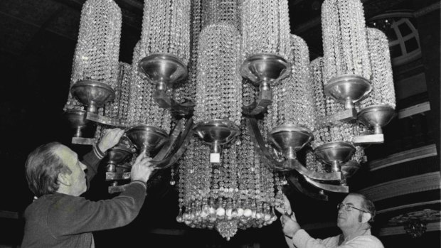 The Regent boasted one of the largest chandeliers in Australia, seen here undergoing major restoration work in 1976. 
