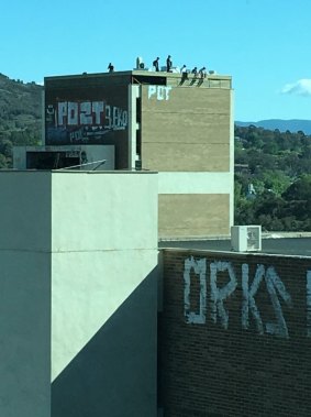 People spotted on the roofs of the abandoned nine-storey Alexander and Albemarle buildings in Woden last October.