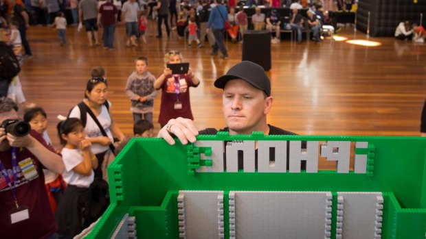 Building a future: Lego fanatic Tim Burdon creates a phone booth at Brickvention, at the Royal Exhibition Building.