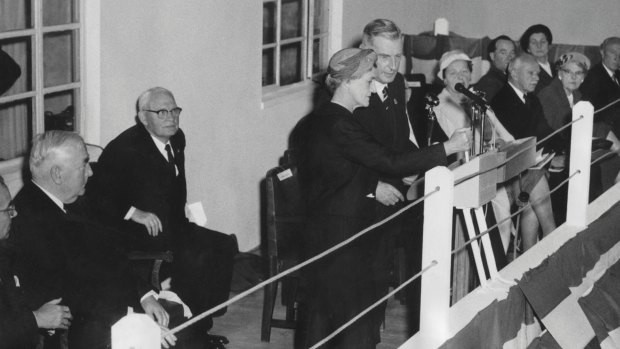 Dame Pattie Menzies, assisted by the Chairman of the Snowy Mountains Authority, Sir William Hudson, closing the switch that brought to life the first of the Snowy Mountain Scheme's huge underground power stations, T.1 in 1959. Seated on the left are prime minister Robert Menzies and the minister for national development Bill Spooner. 