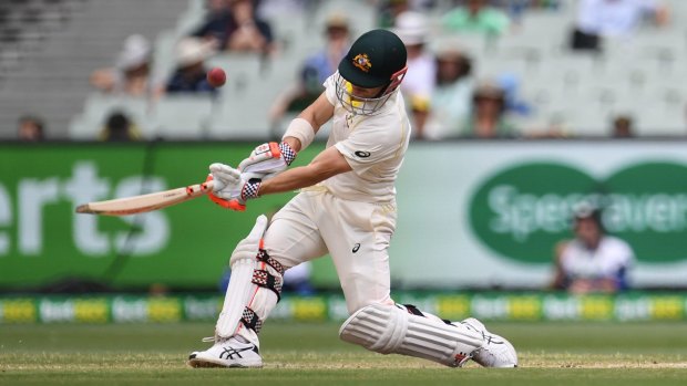 Misstep: David Warner comes down the wicket but is caught out on day five of the Boxing Day Test.
