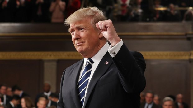 US President Donald Trump pumps a fist.