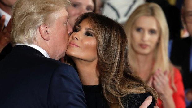President Donald Trump embraces first lady Melania Trump during an event to declare the opioid crisis a national public health emergency.
