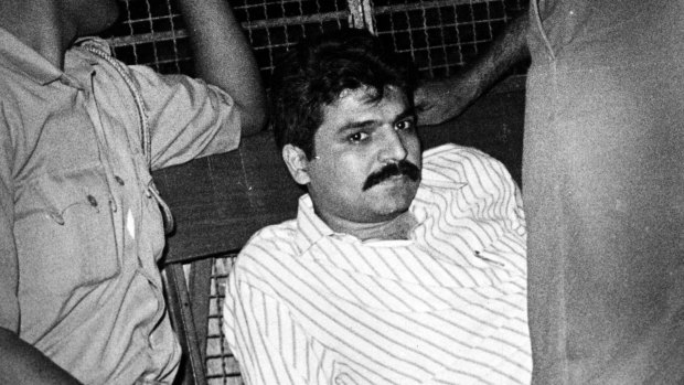 Yakub Memon, right, is taken back to jail in a police vehicle in Mumbai in 1993.