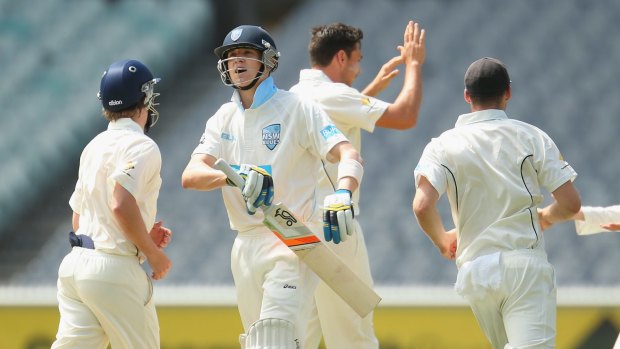 Scott Boland celebrates the dismissal of NSW batsman Nick Larkin during day one of the Sheffield Shield match at the MCG.