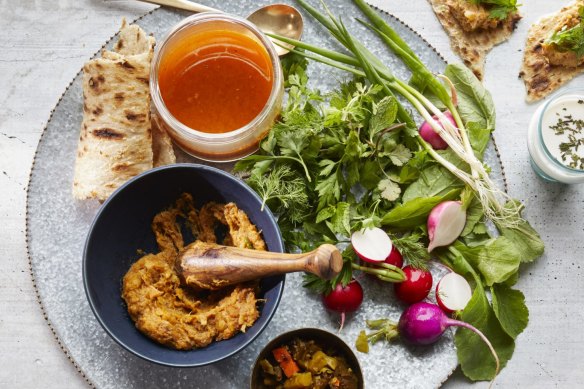 Abgoosht served with flatbread and salad.