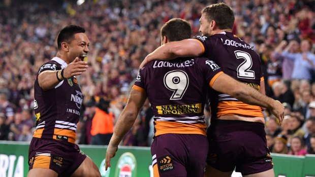 Crucial: Earlier, Corey Oates celebrated scoring a try with Ben Hunt and Alex Glenn.