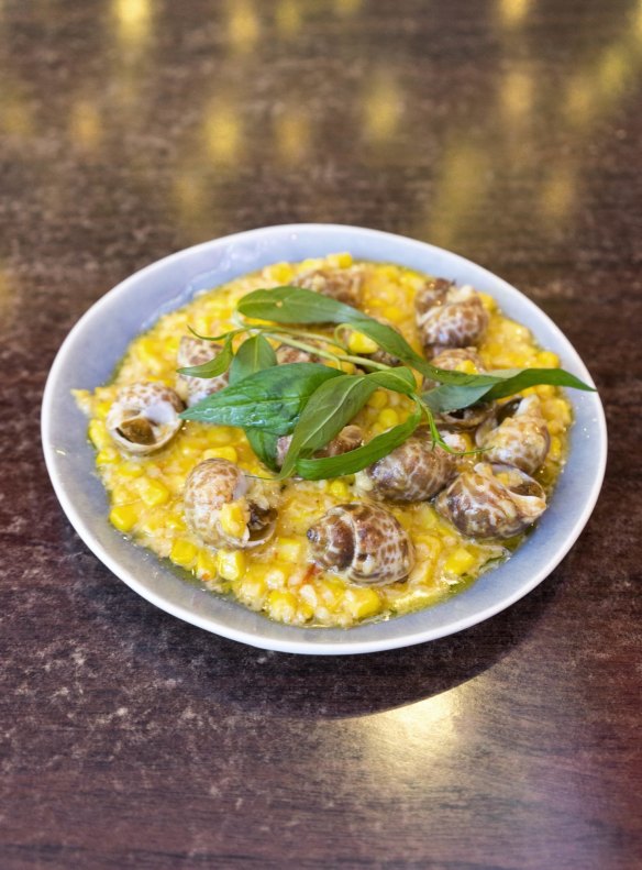 Oc huong (spotted Babylon snails) on butter-drenched sweet corn.