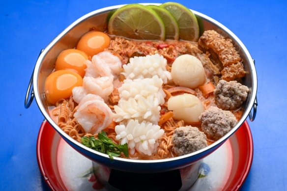 Go-to dish: Ultimate bowl with prawns, scallops, calamari, crispy pork, instant noodles and egg yolks.