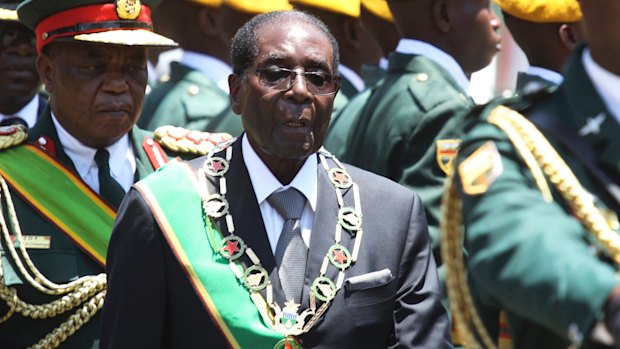 Zimbabwean President Robert Mugabe inspects a guard of honour during the opening of parliament in October.