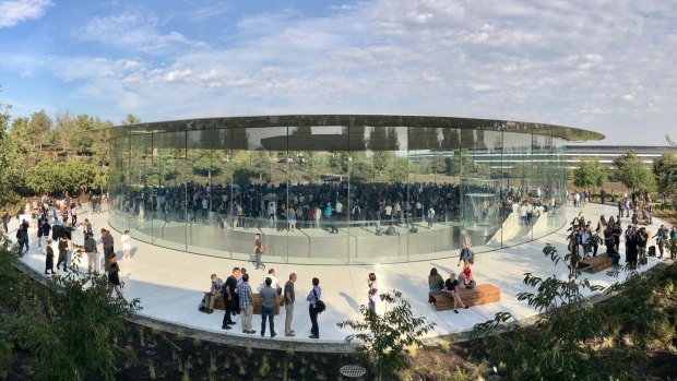 The Steve Jobs Theatre at Apple Park, with the glass-encircled waiting room at ground level, theatre beneath and the main campus visible to the right.