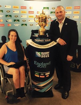 Charlotte Wilkinson-Burnett poses with the Rugby World Cup trophy.