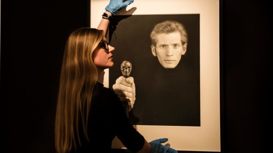 Curator Isobel Parker Philip with one of Mapplethorpe's final self-portraits.