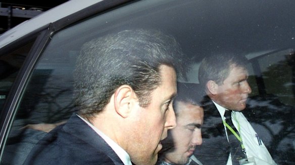 Jason Roberts, centre, is arrested in relation to the police shootings of Gary Silk and Rodney Miller in 1998.