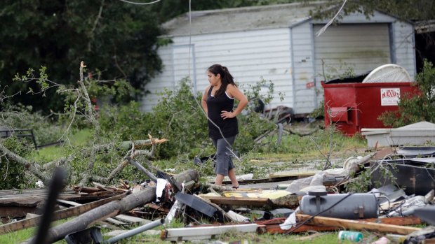 Jennifer Bryant looks over the debris where her family business once stood in the aftermath of Hurricane Harvey in Katy, Texas.