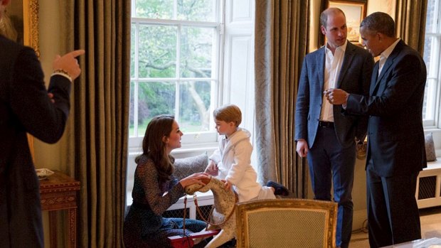 The Duchess of Cambridge plays with Prince George as Prince William and US President Barack Obama look on.
