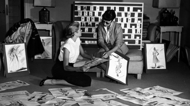 Grace Kelly and Edith Head look over sketches for To Catch a Thief (1955). 