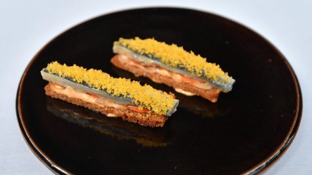Sardine escabeche topped with cured egg.