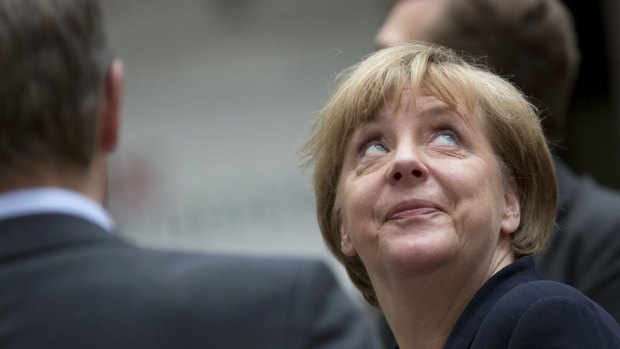 German Chancellor Angela Merkel looks up before a summit over the Greek crisis in Brussels on Tuesday. Now on a tour of the Balkans, she cannot forget Greece's problems affect the whole region.