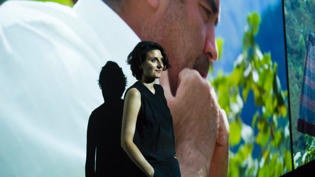 Artist Angelica Mesiti stands in her three-channel HD video installation at the National Gallery of Australia. 