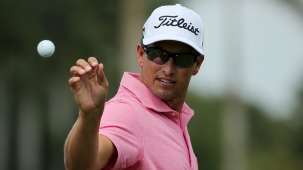 Practice makes perfect: Adam Scott of Australia catches his ball on the practice range before the start of play.