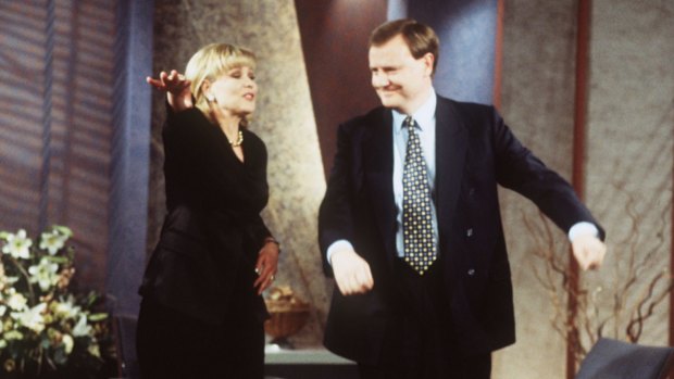 Former treasurer and current Nine chairman, Peter Costello, does the macarena with Kerri-Anne in 1996. 
