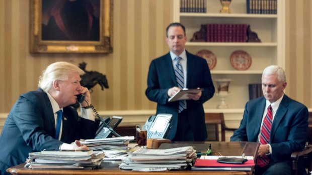 President Donald Trump, accompanied by Chief of Staff Reince Priebus and Vice-President Mike Pence, speaks on the phone with  Russian President Vladimir Putin.