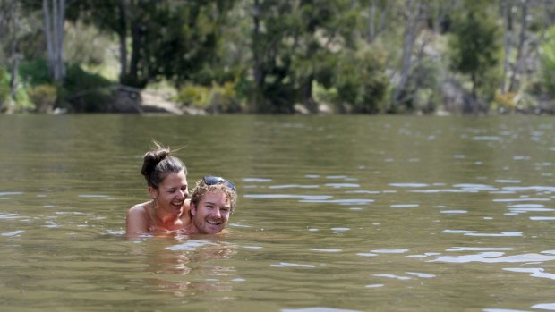 James Foster and Sharnel Chatworthy cool off in the cold water of at the Kambah Pools.