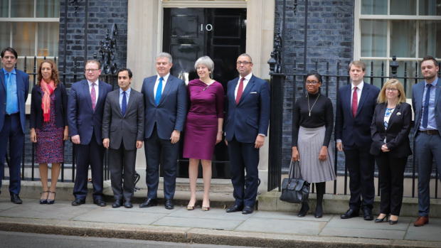 British Prime Minister Theresa May, centre, with the new Conservative party chairman Brandon Lewis, left, deputy chairman James Cleverly right.