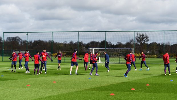 State of the art: The England football team warm up at Enfield during a training session.