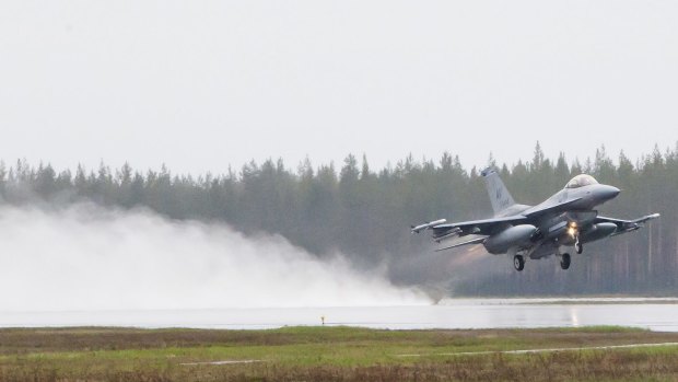 A US F-16CM fighter takes off from Kallax Airport outside Lulea, in northern Sweden, during the Arctic Challenge Exercise.