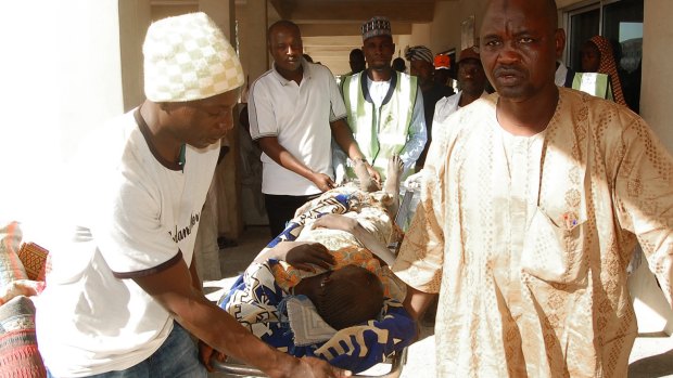 Rescue workers transport a victim of a suicide bomb attack at a refugee for treatment at a hospital in Maiduguri, Nigeria, on Wednesday.