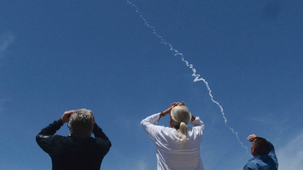 Spectators watch an interceptor missile launch from an underground silo at Vandenberg Air Force Base.