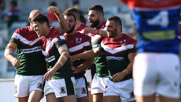 Lebanon teammates mob Mitchell Moses after his incredible chip-and-chase try.