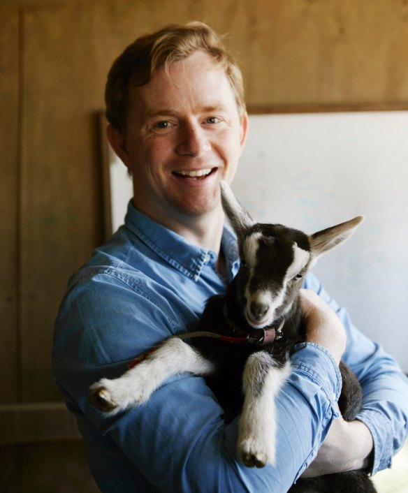 Phil Wood with one of the kids at Main Ridge Dairy.