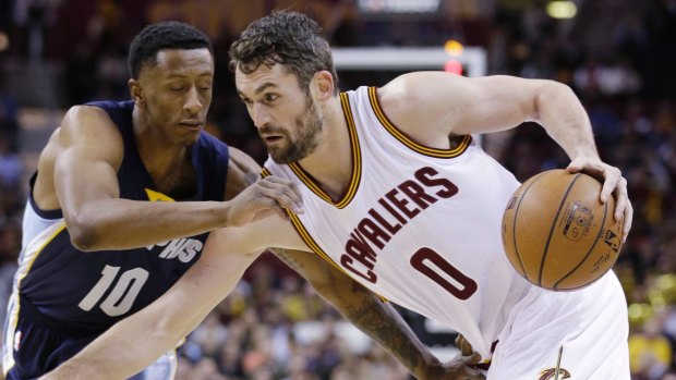 Kevin Love drives past Troy Williams.