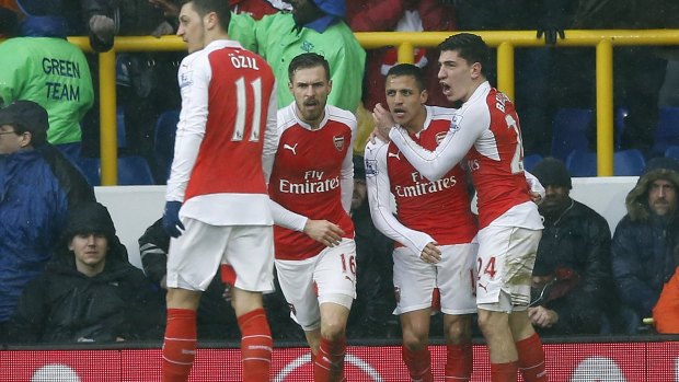 Arsenal's Alexis Sanchez, second right, celebrates after scoring his side's second goal.