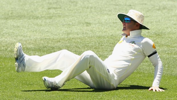 Down and out: Michael Clarke hits the deck after tearing his hamstring in Adelaide.