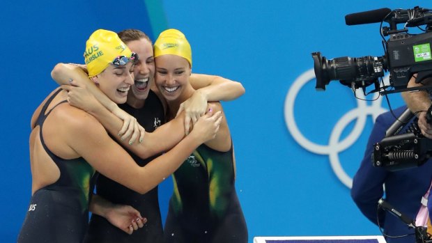 Australia's Emma McKeon, Brittany Elmslie and Bronte Campbell celebrate gold in the 4 by 100m freestyle relay at the Rio Olympics.