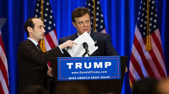A Trump campaign aide covers the microphone while Paul Manafort checks the teleprompter ahead of a Donald Trump speech in New York in June.