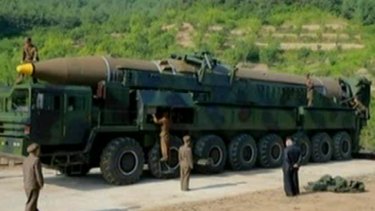 A picture from North Korean media which purports to show the intercontinental ballistic missile launched on July 4, 2017. Kim Jong-un is apparently standing on the right, in a dark suit.