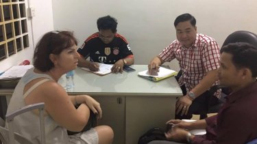 Crackdown: Australian nurse and surrogacy broker Tammy Davis-Charles is questioned by Cambodian police.