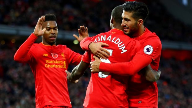 Georginio Wijnaldum, Emre Can and Daniel Sturridge celebrate a Liverpool goald.