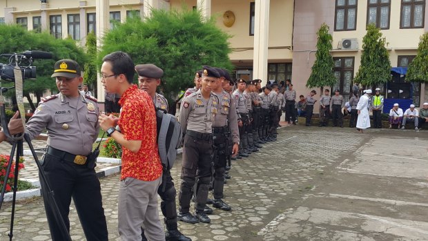 Police line up outside the Cilacap court where Abu Bakar Bashir's trial is taking place in Cilacap, Indonesia, on Tuesday.
