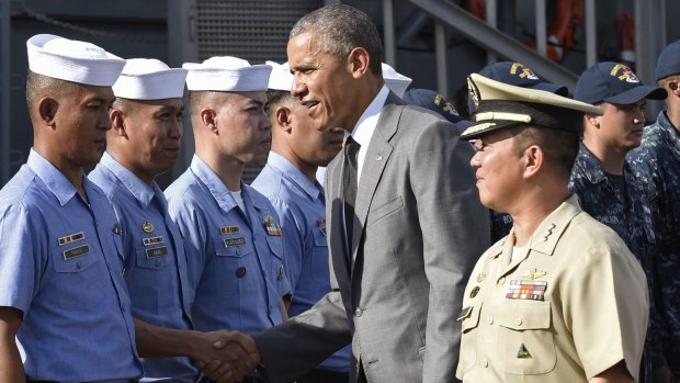 US President Barack Obama, centre, greets sailors while touring the Philippines navy frigate, Gregorio del Pilar, with Captain Vince Sibala, front right, commanding officer of the frigate.