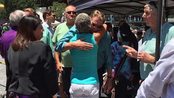 Well-wishers greet Cole Miller's father Steve at the a memorial.