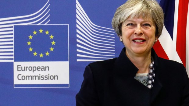 Theresa May, U.K. prime minister, poses for photographs ahead of a meeting at the European Commission building in Brussels, Belgium, on Monday.