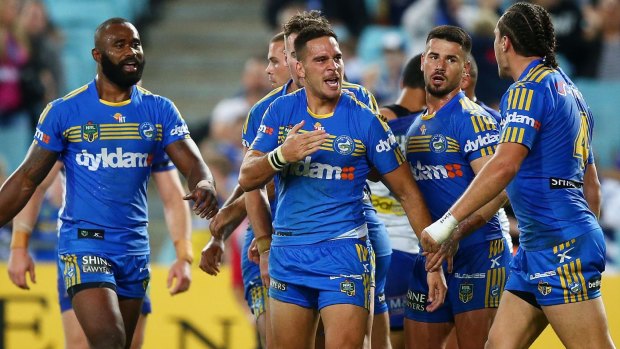 Last-start winners: Corey Norman celebrates his try with Eels teammates during the match against the Bulldogs.