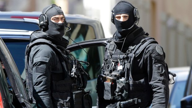 Hooded police officers involved in the arrest of two men in Marseille, southern France.