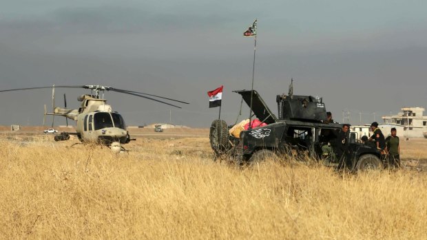 Offensive underway: an Iraqi military helicopter makes emergency landing outside Mosul.